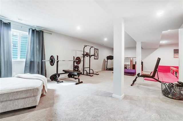 exercise room with light carpet, baseboards, and visible vents