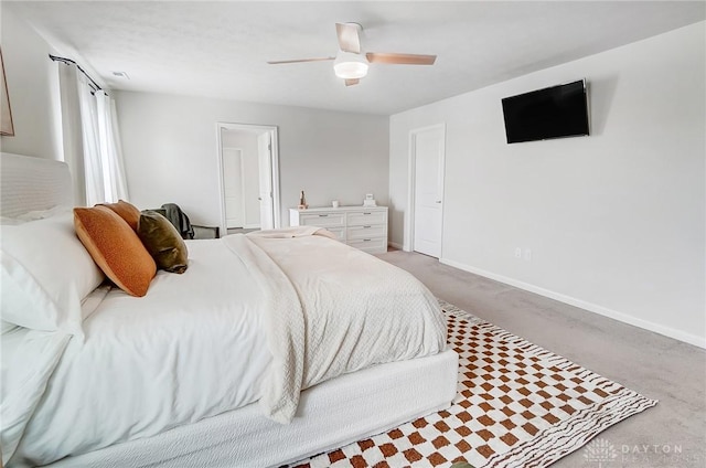 carpeted bedroom featuring baseboards and a ceiling fan