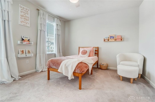 bedroom featuring baseboards and light colored carpet