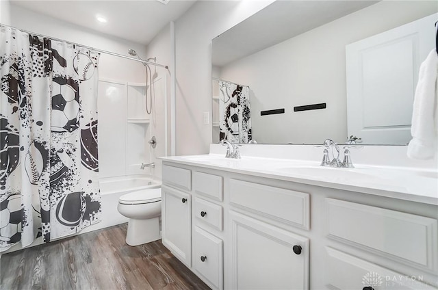 full bath featuring vanity, shower / tub combo, wood finished floors, and toilet