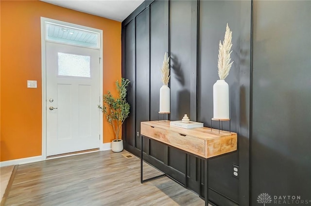 interior space with baseboards and wood finished floors