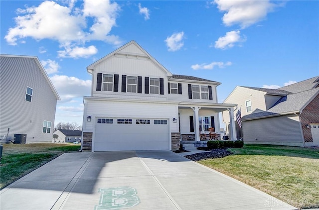 view of front facade with covered porch, a garage, concrete driveway, a front lawn, and board and batten siding