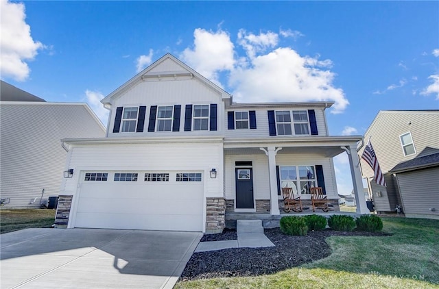 craftsman inspired home featuring driveway, a garage, stone siding, covered porch, and board and batten siding