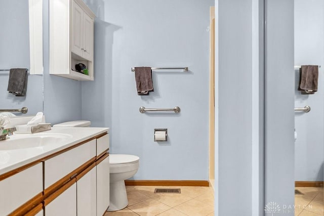 bathroom with toilet, vanity, visible vents, and tile patterned floors