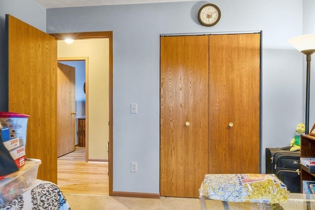 bedroom with baseboards and a closet