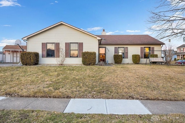 ranch-style house with a front lawn and a chimney