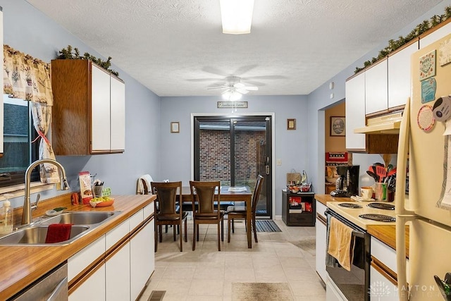 kitchen featuring light countertops, white appliances, a sink, and white cabinetry