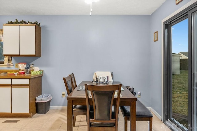 dining room with visible vents, baseboards, and light tile patterned flooring