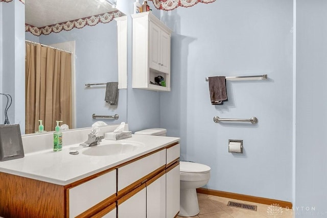 bathroom featuring baseboards, visible vents, toilet, tile patterned floors, and vanity