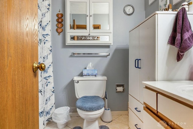 bathroom with curtained shower, toilet, vanity, baseboards, and tile patterned floors