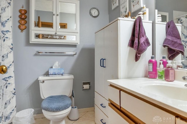 full bathroom with vanity, tile patterned flooring, toilet, and baseboards