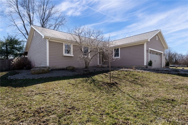 ranch-style house featuring an attached garage, fence, and a front yard