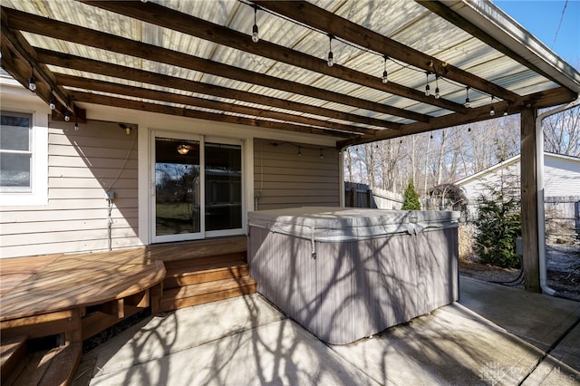 view of patio featuring a deck, fence, and a hot tub