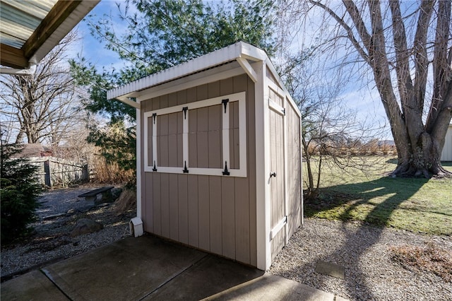 view of shed featuring fence