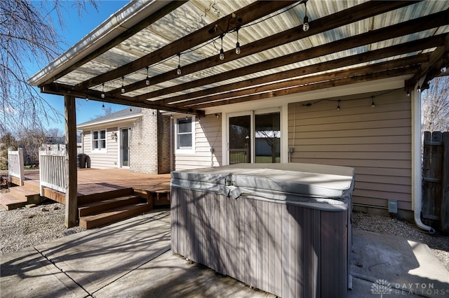 view of patio with a wooden deck and a hot tub