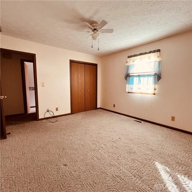 1181/2 Springlake Ave Middle, Unit Middle, Hillsboro, OH 45133 - unfurnished bedroom with a textured ceiling, light carpet, a closet, and a ceiling fan