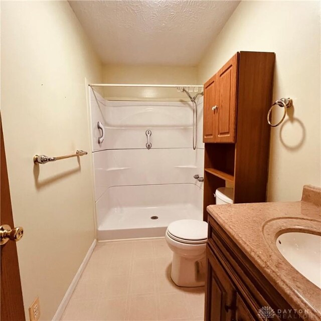 1181/2 Springlake Ave Middle, Unit Middle, Hillsboro, OH 45133 - bathroom with a textured ceiling, a shower, vanity, and tile patterned floors
