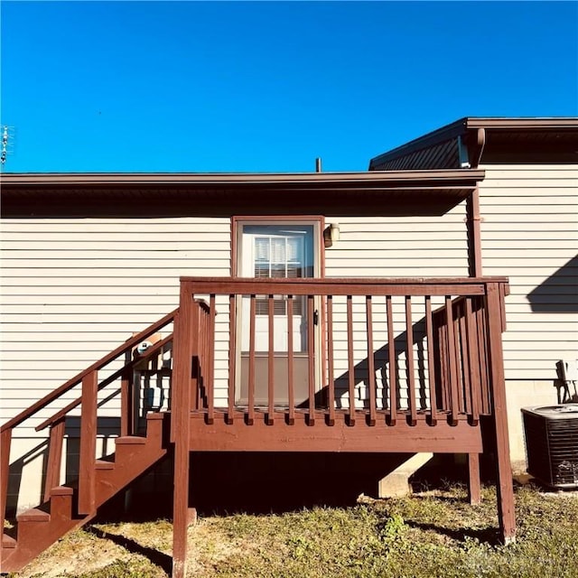 deck featuring cooling unit and stairs