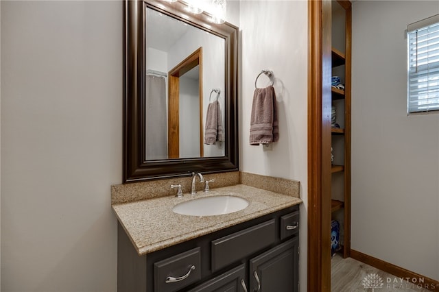 bathroom featuring vanity and baseboards