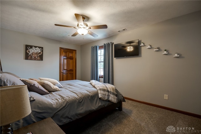 carpeted bedroom featuring a ceiling fan, visible vents, baseboards, and a textured ceiling