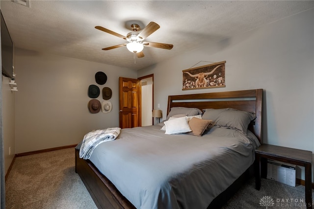 carpeted bedroom featuring ceiling fan, baseboards, and a textured ceiling