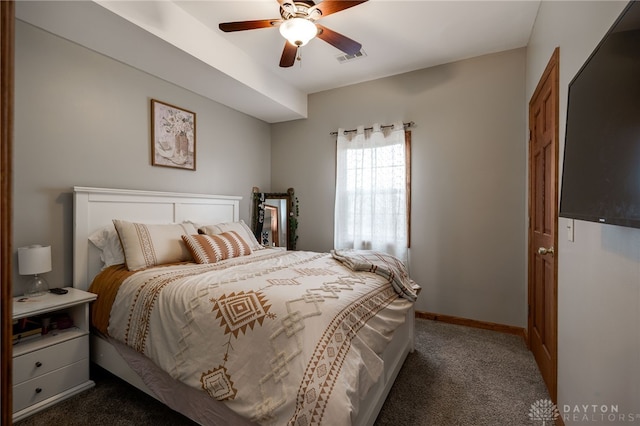 carpeted bedroom featuring baseboards, visible vents, and ceiling fan