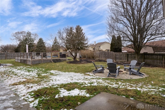 view of yard featuring fence private yard, an outdoor fire pit, and a deck