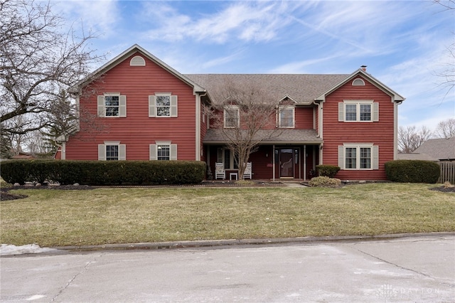 traditional-style home with a front lawn