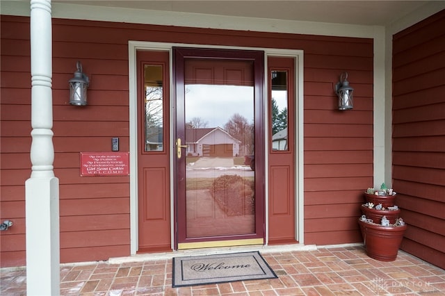 view of exterior entry featuring a porch