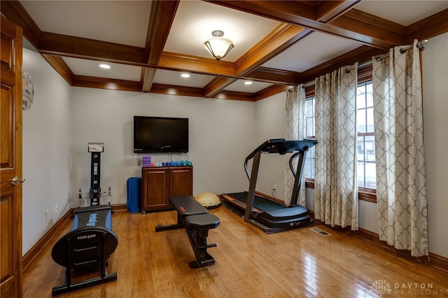 workout area with coffered ceiling, wood finished floors, visible vents, and baseboards