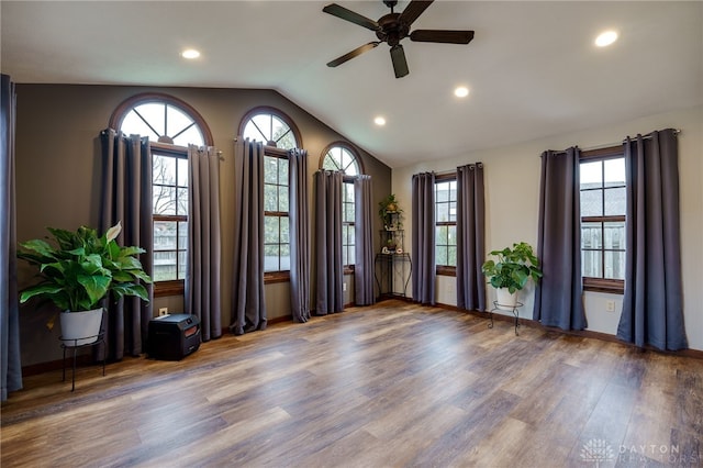 empty room with vaulted ceiling, wood finished floors, a ceiling fan, and recessed lighting