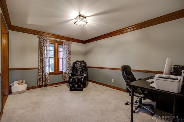 carpeted home office featuring ornamental molding and baseboards