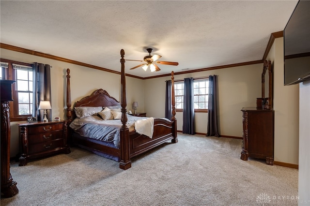 bedroom featuring multiple windows, light carpet, baseboards, and a textured ceiling