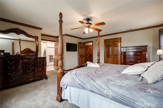 carpeted bedroom featuring a ceiling fan, connected bathroom, visible vents, and crown molding