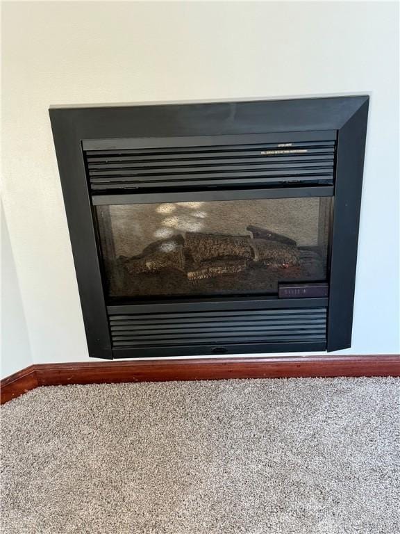 interior details featuring carpet and baseboards