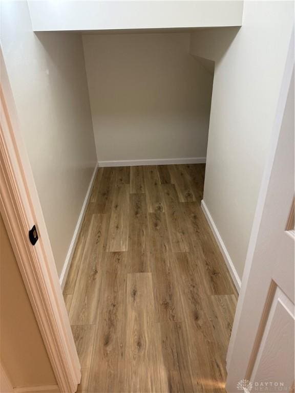 interior space with wood finished floors and baseboards