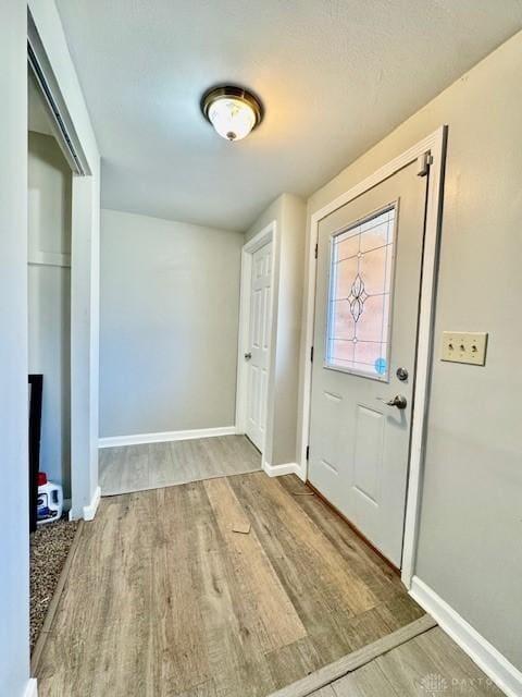 entrance foyer featuring wood finished floors and baseboards