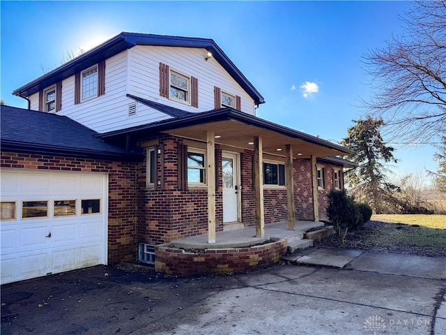 view of front of house featuring an attached garage, driveway, roof with shingles, and brick siding