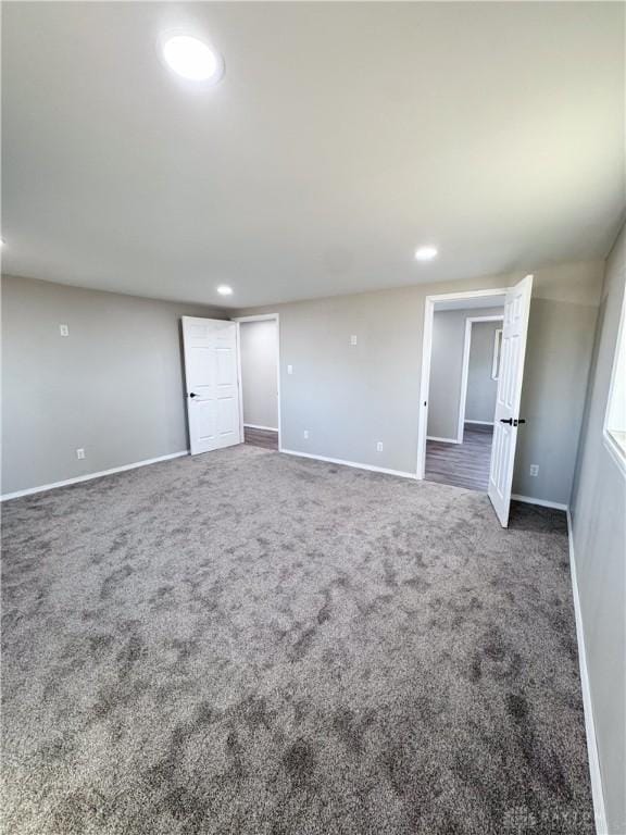 unfurnished room with carpet, baseboards, and recessed lighting