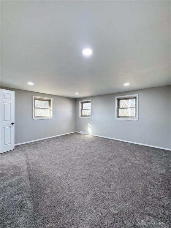 basement featuring carpet, baseboards, and recessed lighting