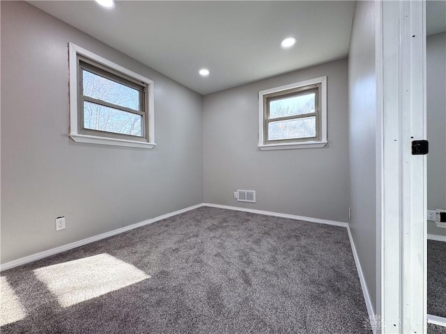 carpeted empty room with recessed lighting, visible vents, and baseboards