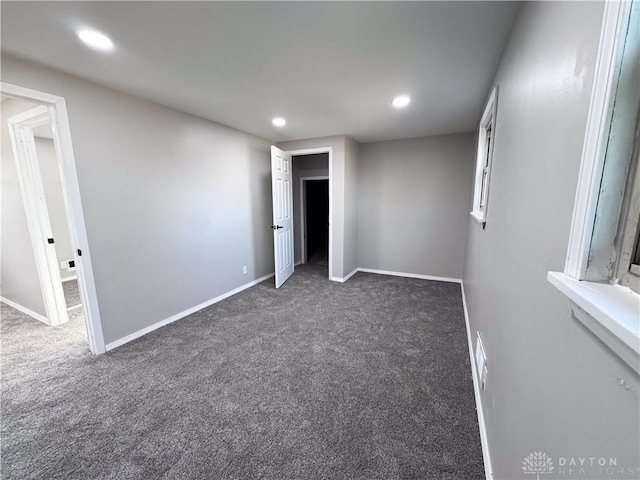 carpeted spare room featuring recessed lighting, visible vents, and baseboards