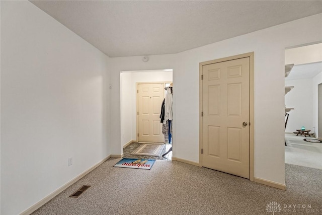 interior space featuring baseboards and visible vents