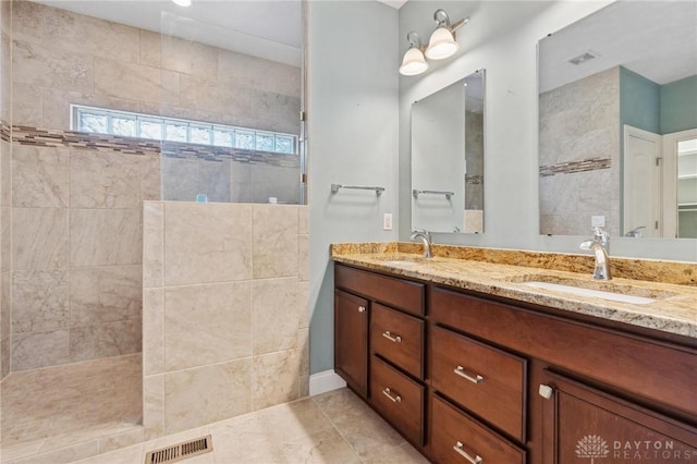 full bath with visible vents, a sink, and walk in shower