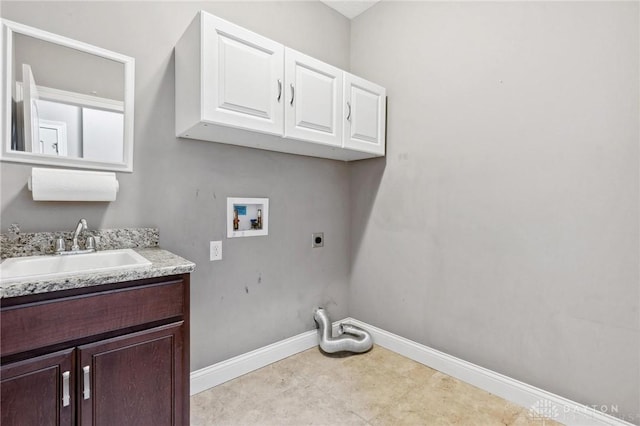 laundry room with cabinet space, baseboards, hookup for a washing machine, hookup for an electric dryer, and a sink