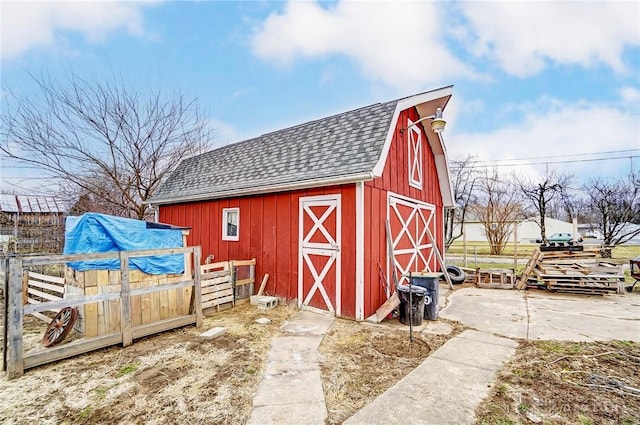 view of barn featuring fence