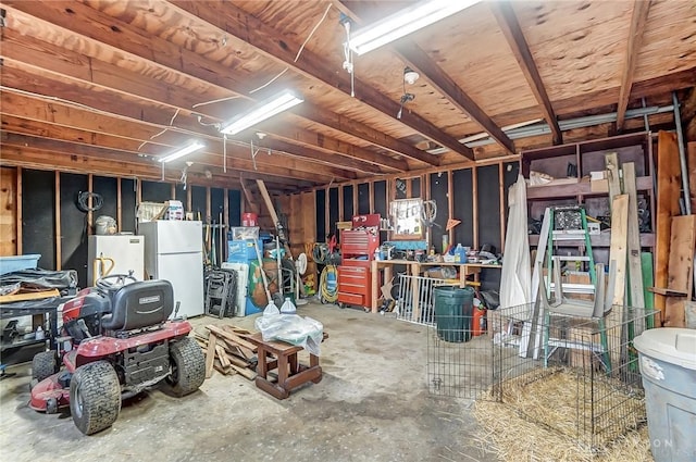 interior space with a workshop area, fridge, and freestanding refrigerator