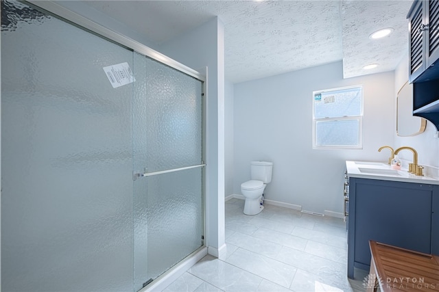 bathroom with a textured ceiling, tile patterned flooring, vanity, baseboards, and a stall shower