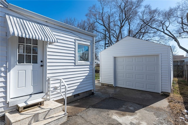 detached garage with driveway and fence