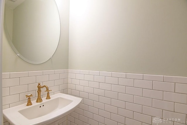 9471 Banyan Ct, Dayton, OH 45458 - bathroom featuring a wainscoted wall, a sink, and tile walls